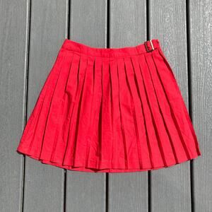 Cherry red pleated mini skirt with belt buckle detail, preppy indie sleaze